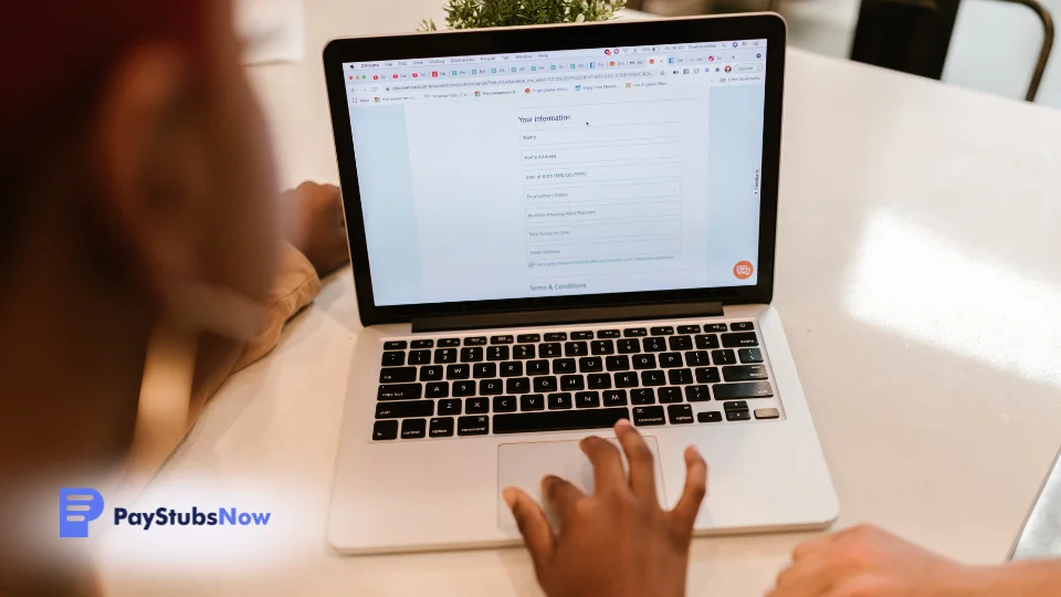 Two people working on a laptop at a table