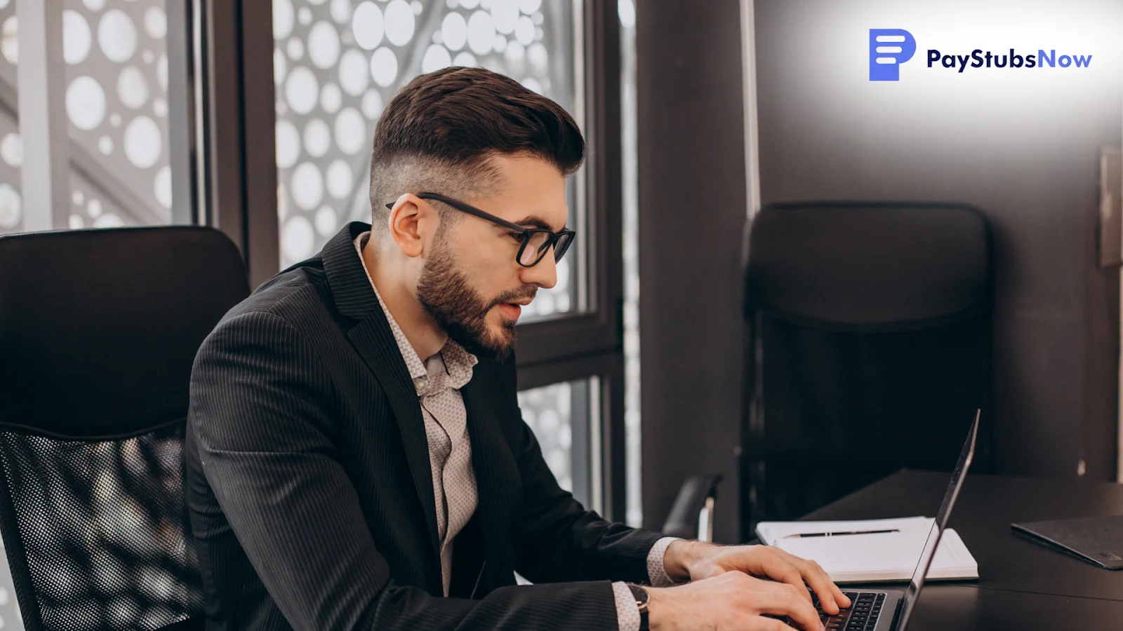 A professional man working on a laptop, researching payment methods.