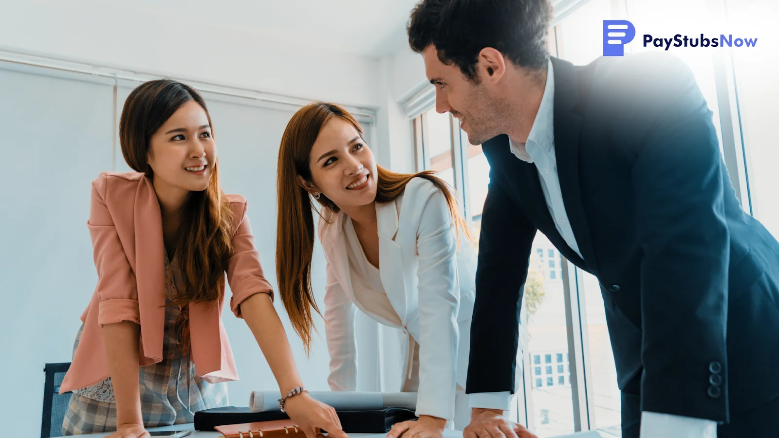 Three coworkers standing at a table discussing who must file a 1099-NEC (and who doesn't) for their business.