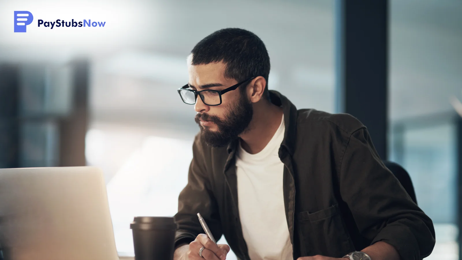 A focused man with a beard and glasses learning how to fill out each box on Form 1099-NEC.